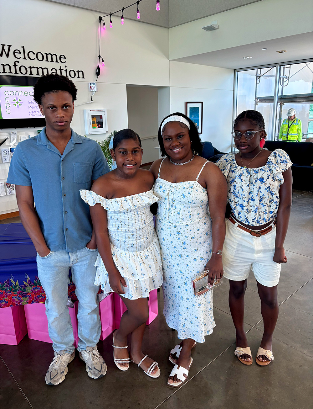 Motherhood concept. Happy smiling mom with adorable daughter on arms resting at home, looking at